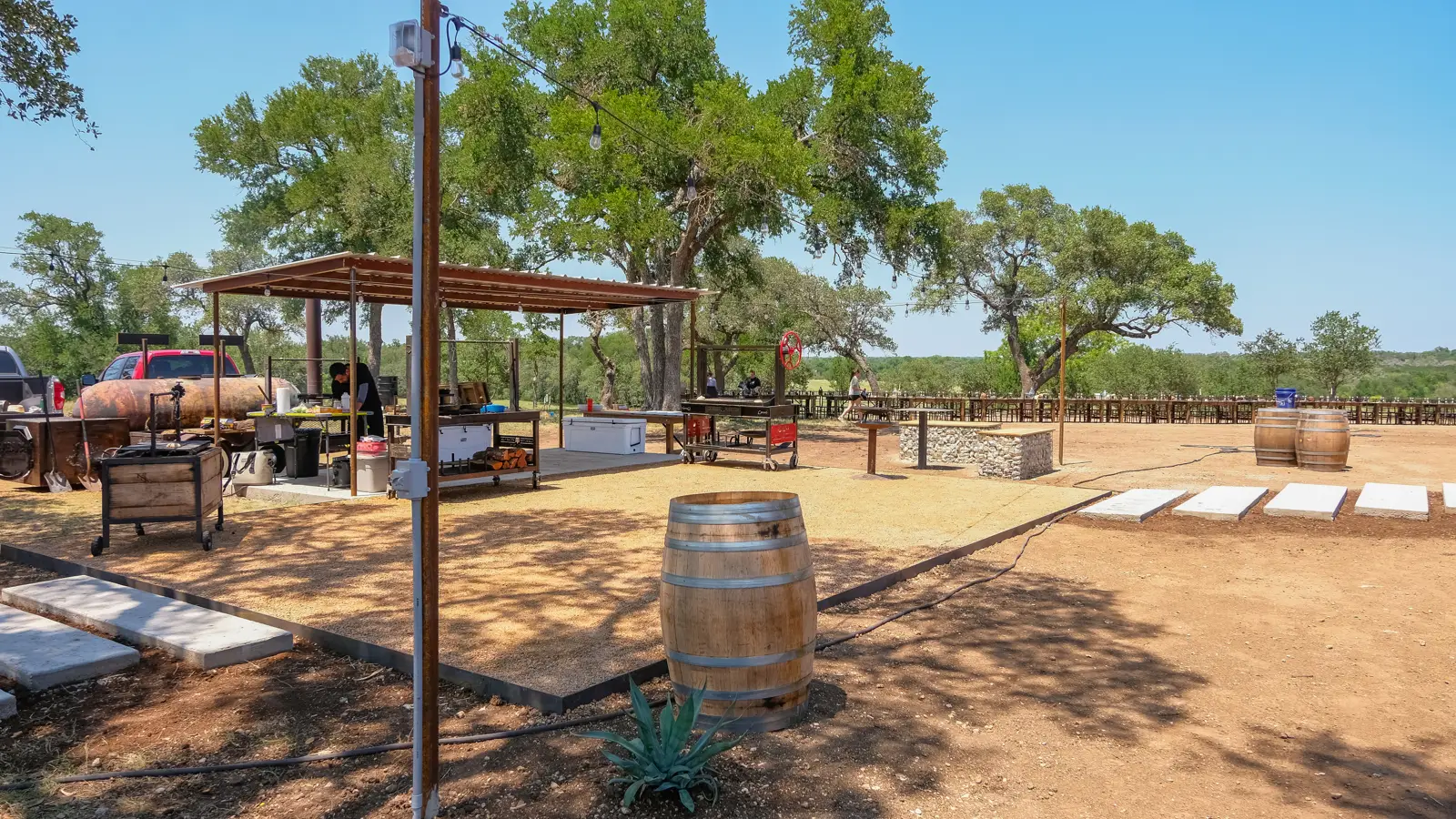Completed gathering area with covered seating and gravel surfaces.